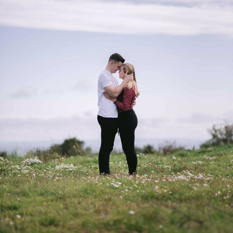 Engaged couple embrace each other on Hope Mountain North Wales
