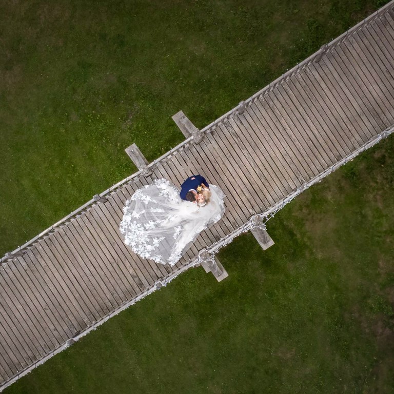 Ariel photography of a Bride & Groom standing on a bridge during a Chester wedding