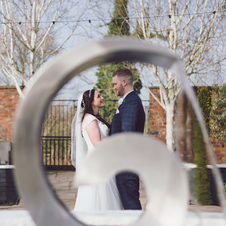 Bride & Groom portrait through fountain at Lion Quays