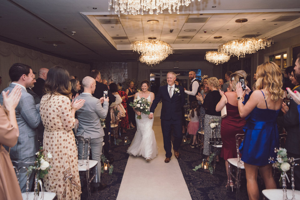Bride & Groom walk up aisle at Rowton Hall Hotel wedding