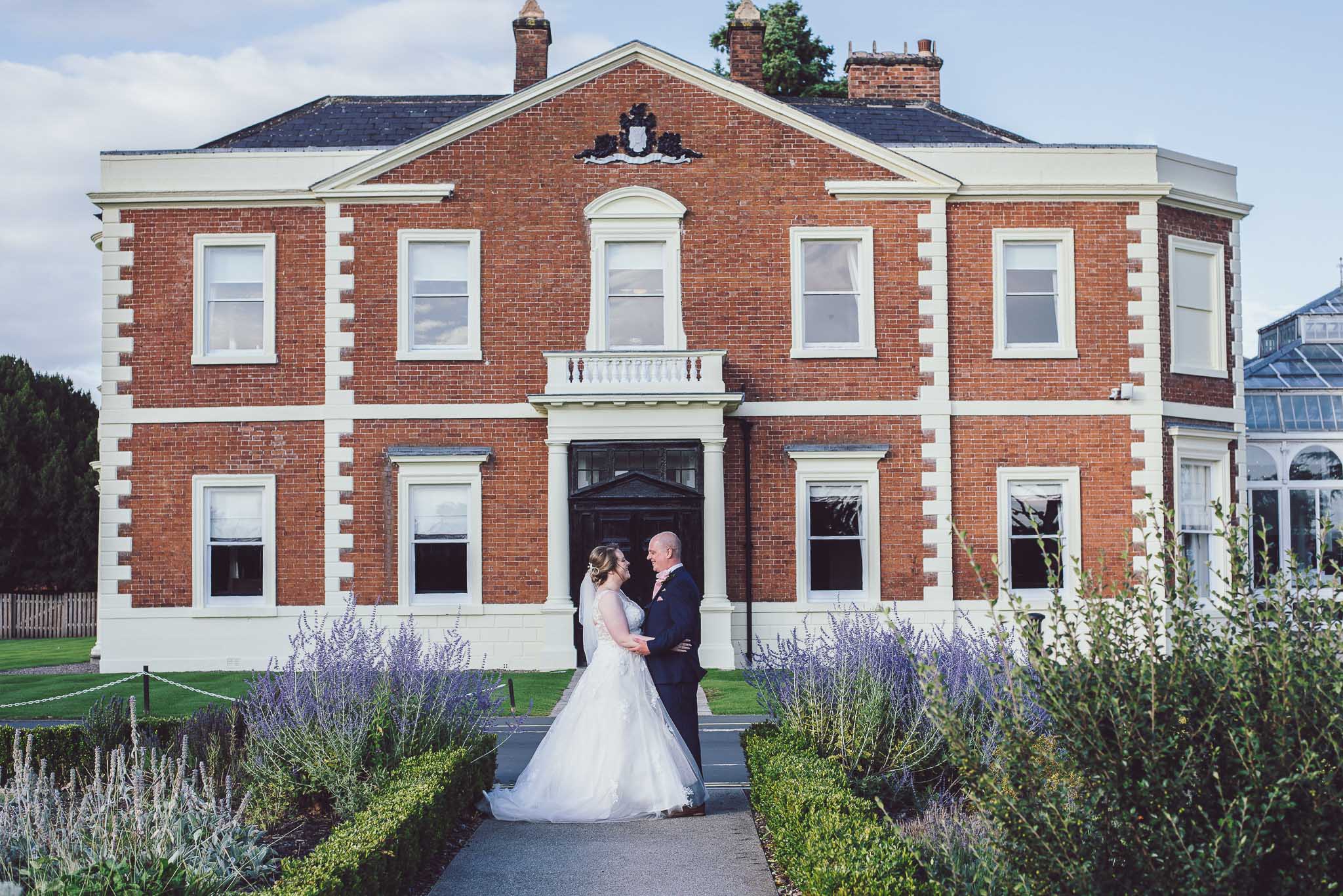 Bride & Groom standing in front of the DoubleTree Hilton in Chester, Cheshire