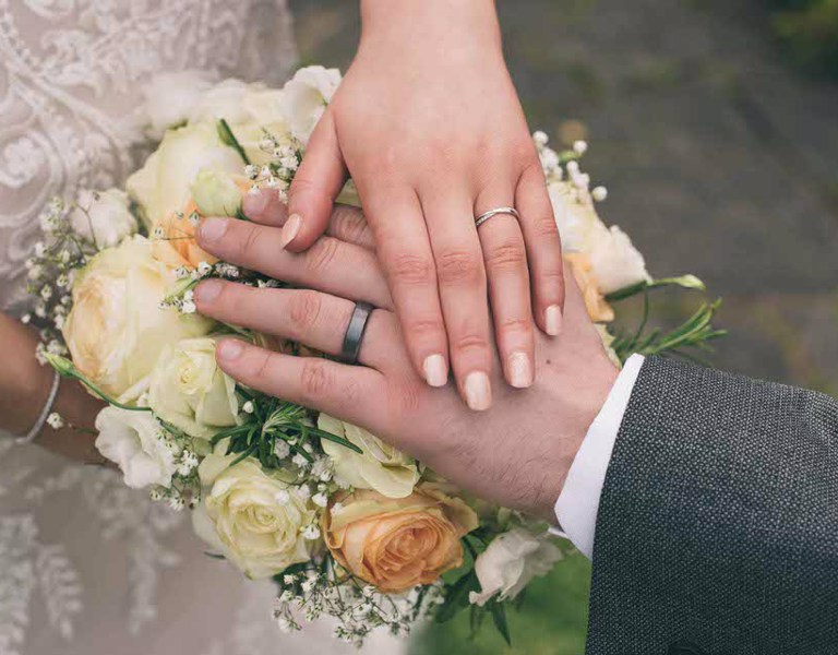 Wedding day close up of hands and wedding rings