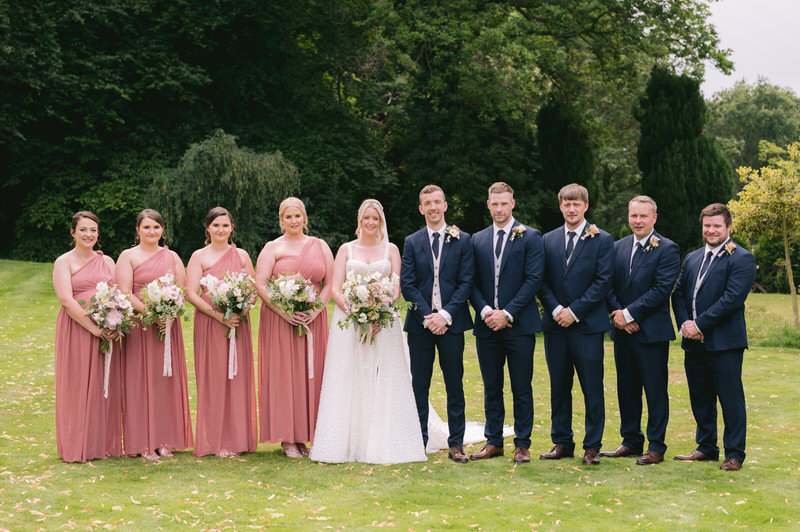 Bride & Groom walk up driveway and chat during wedding photography at Highfield Hall