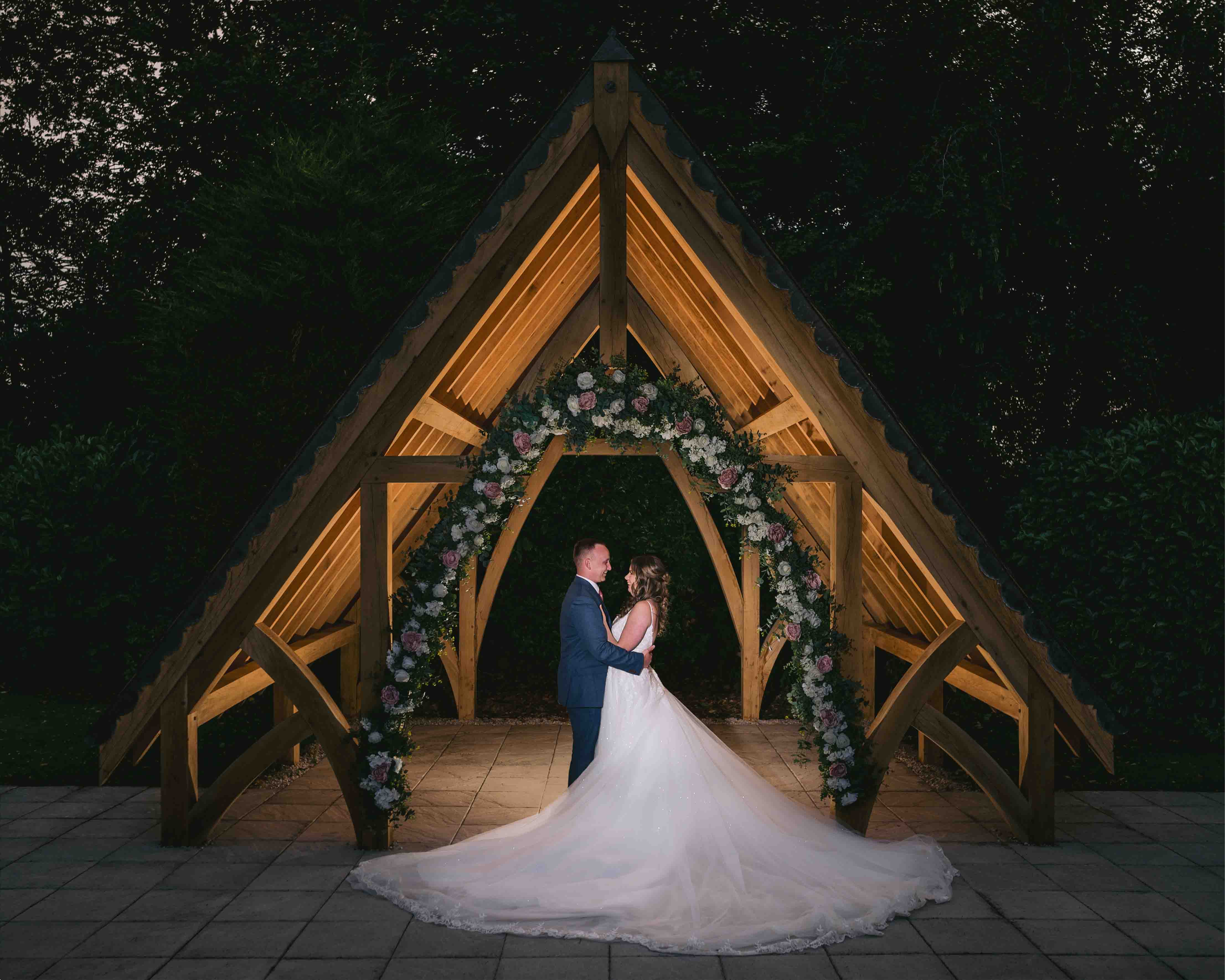 Bride & Groom outside Highfield hall wedding venue at night time under lit up pagoda 