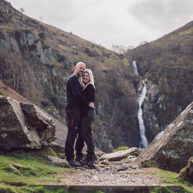 Couple hold each other during pre-wedding shoot in North Wales