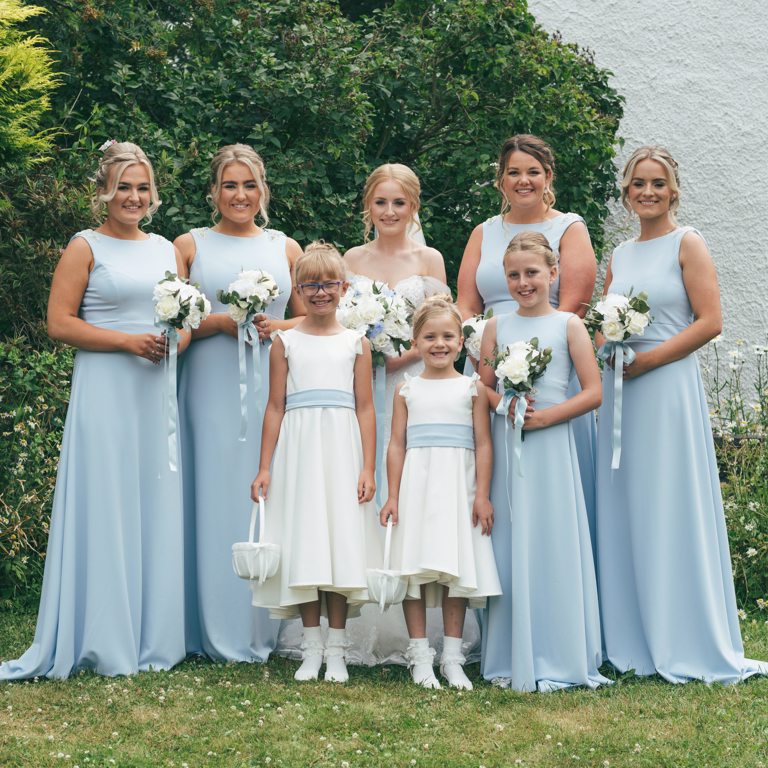 Bridal party pose outside bridal prep venue in North Wales