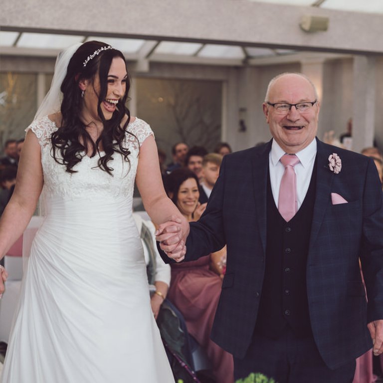 Bride & Father laugh during ceremony at Lion Quays Shropshire