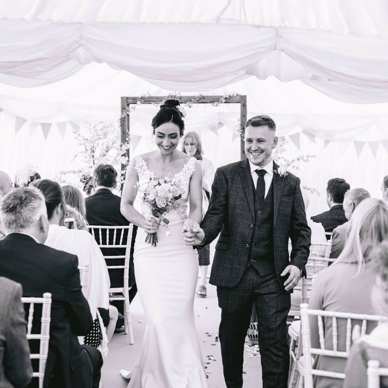 Bride and Groom exit ceremony after Marquee wedding in Penyffordd North Wales
