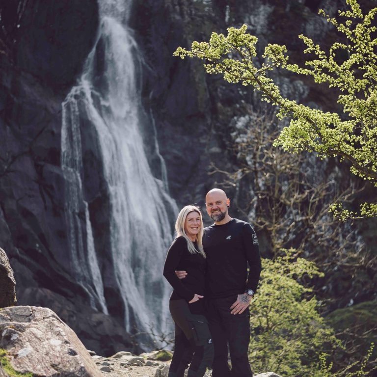 Couple pose in front of Aber Falls North Wales