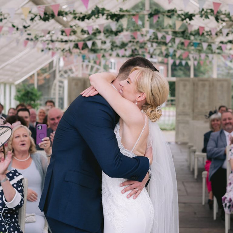 Bride & Groom hug in grounds of Abbeywood Estate, Cheshire for wedding photos