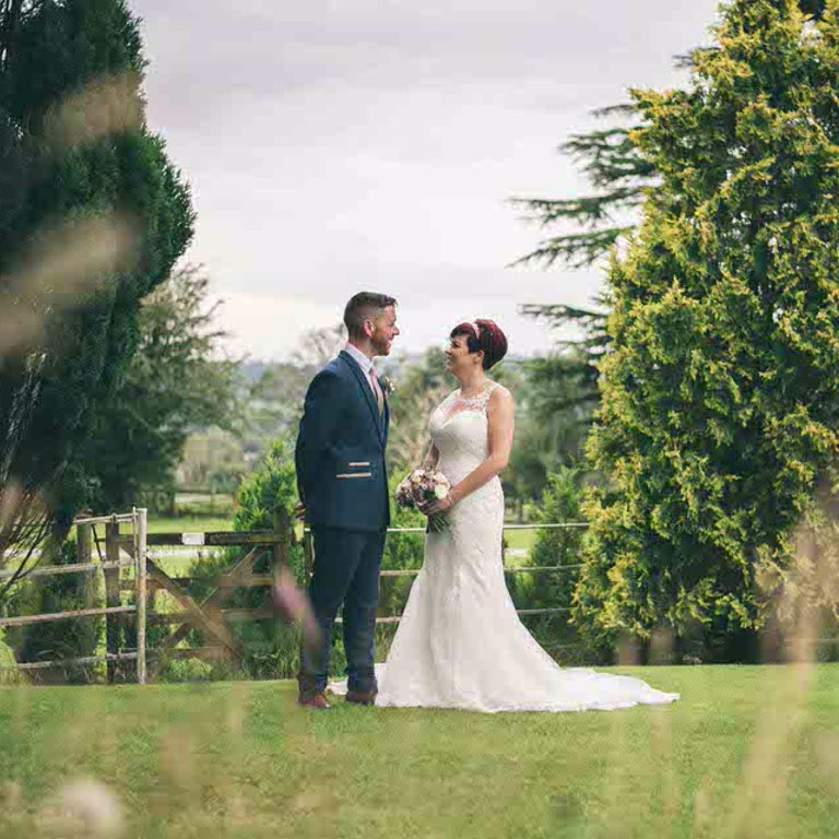 Wedding photography, Bride & Groom laugh outside of Highfield Hall, Flintshire