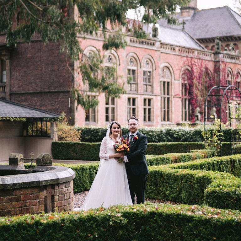 Bride & Groom stand in front of Soughton Hall, Flintshire for wedding photos