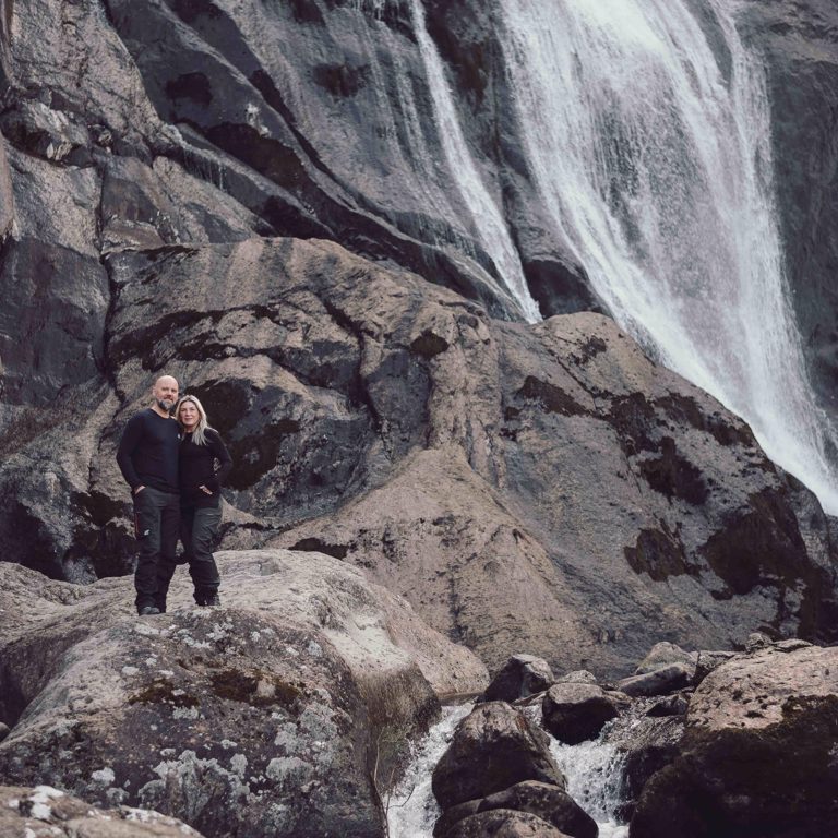 Couple on top of rocks in front of Aber Falls North Wales