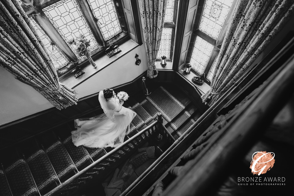 Photograph of Bride on stairs, during wedding at Wigfair Hall, North wales