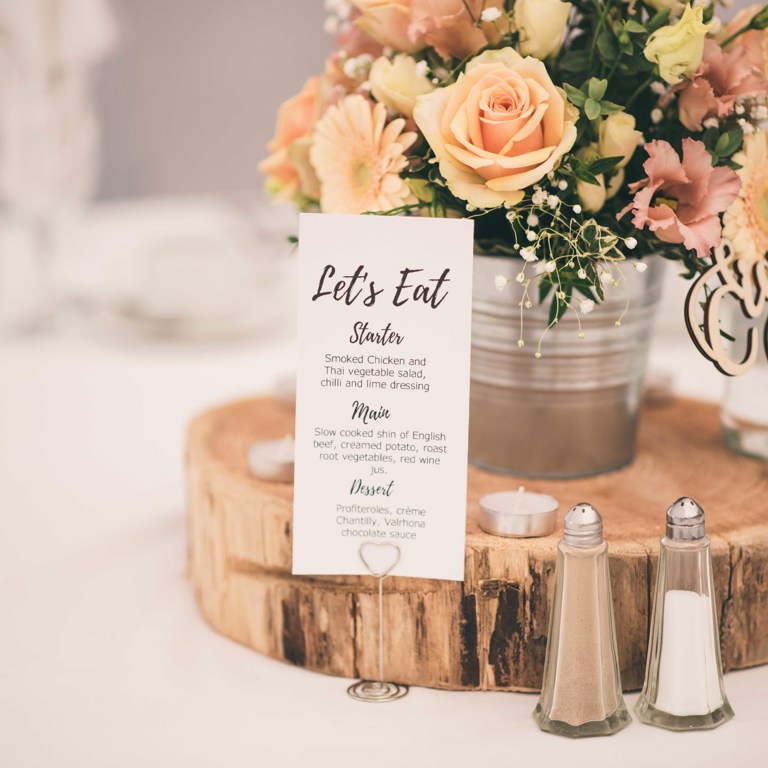 Table centre pieces saying 'let's eat' at Lion Quays wedding