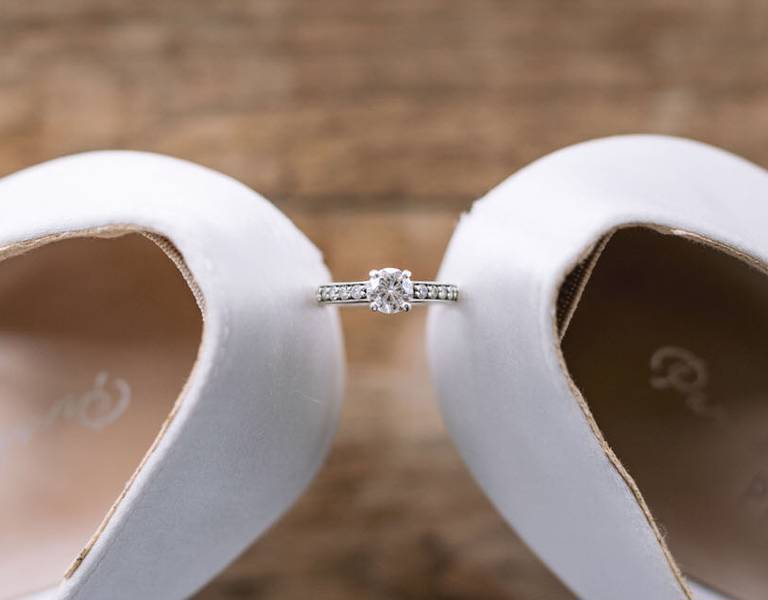 Close of photograph of wedding shoes and engagement ring