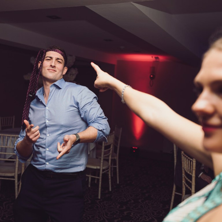 Wedding guest dances with tie around his head at Rossett Hall