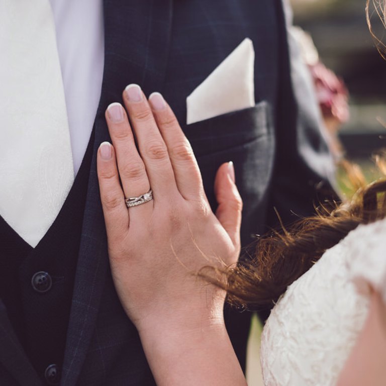 Close up photograph of brides wedding ring on hand at Lion Quays