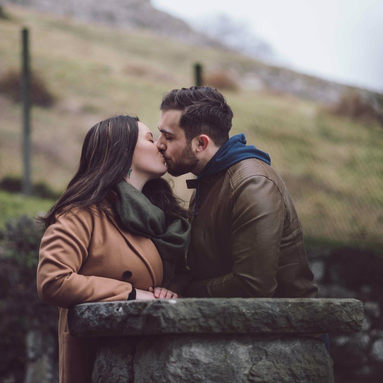 Couple kiss during pre-wedding shoot in North Wales