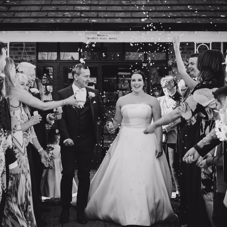 Bride & Groom get showered in confetti outside Rossett Hall