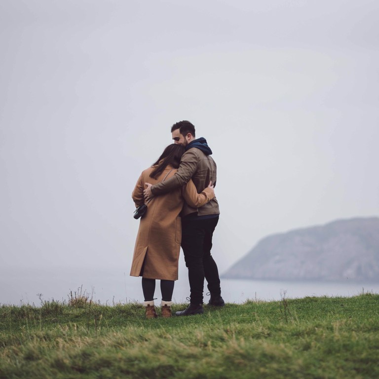 Couple overlooking sea in Llandudno North Wales