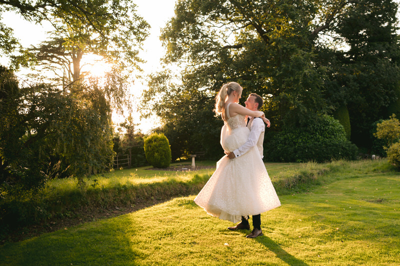 Groom lifts his Bride on wedding day at Highfield Hall wedding venue in Northop
