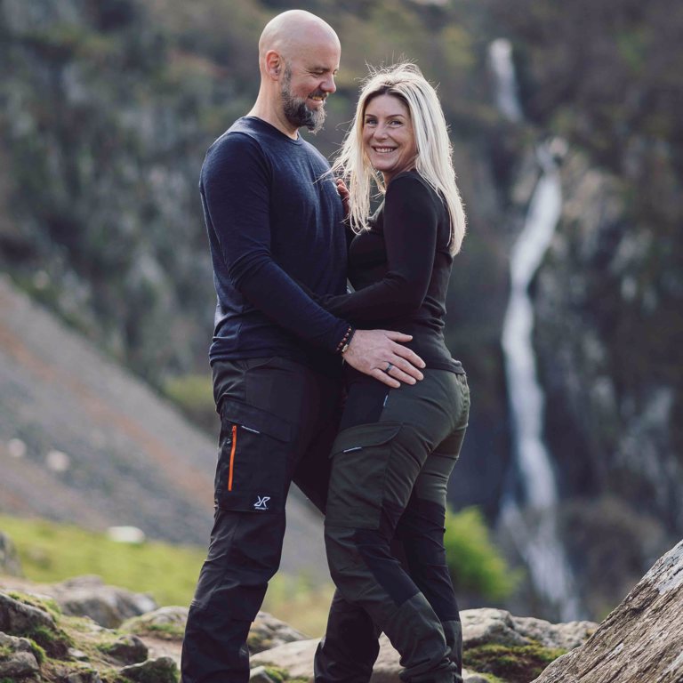 Couple pose in front of Aber Falls during pre-wedding shoot 