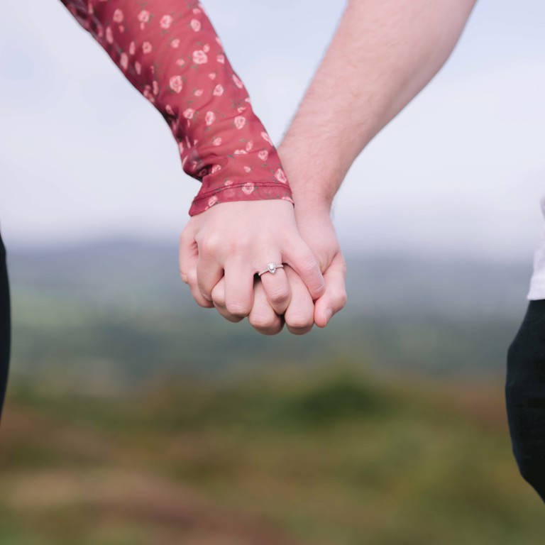 Engagement couple hold hands on Hope Mountain North Wales