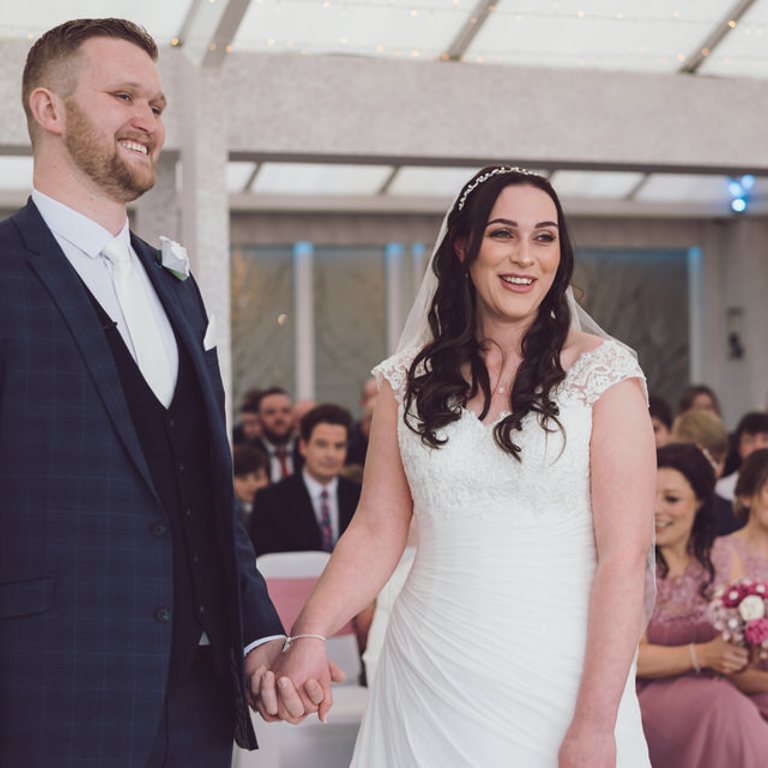 Bride & Groom smile during ceremony at Lion Quays Oswestry