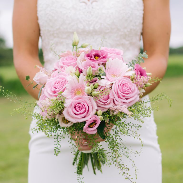 Bride holding bouquet of flowers at wedding in Penyffordd North Wales