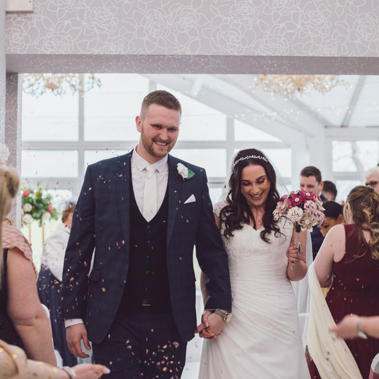 Bride & Groom walks back down aisle at Lion Quays Oswestry