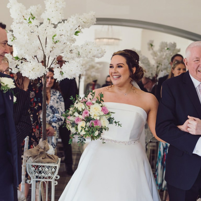 Bride & Father smile during ceremony at Rossett Hall