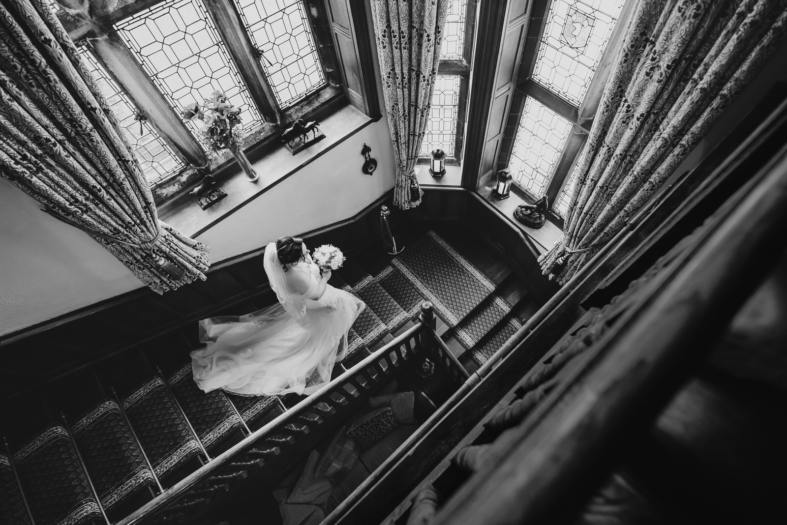 Bride walks down staircase on the way to wedding ceremony at Wigfair Hall