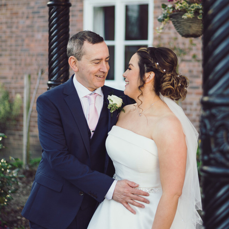 Bride & Groom portrait outside under pergola at Rossett Hall