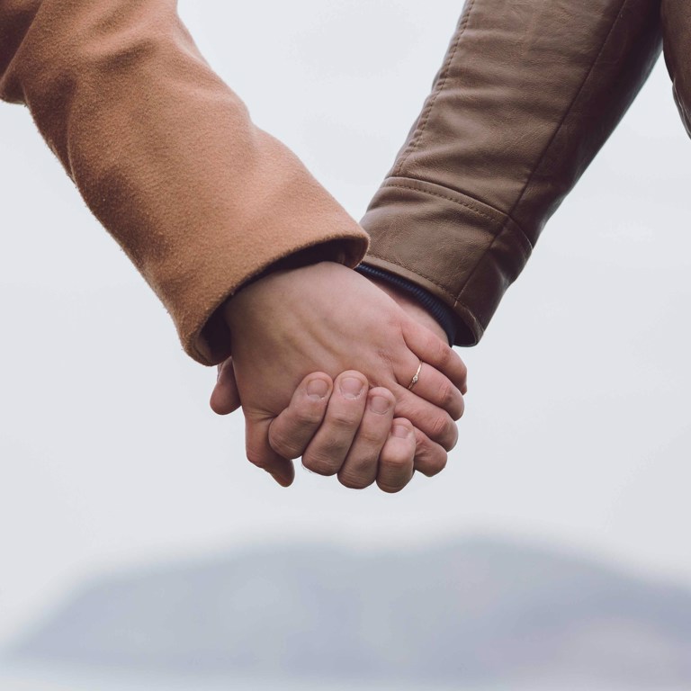 Couple holding hands in Llandudno North Wales