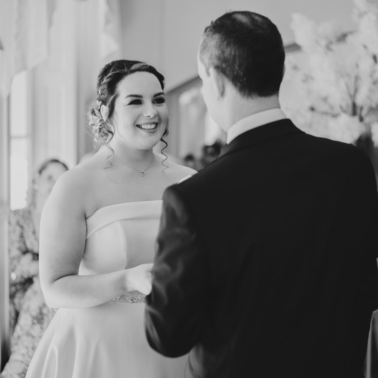 Bride & Groom hold hands during ceremony at Rossett Hall