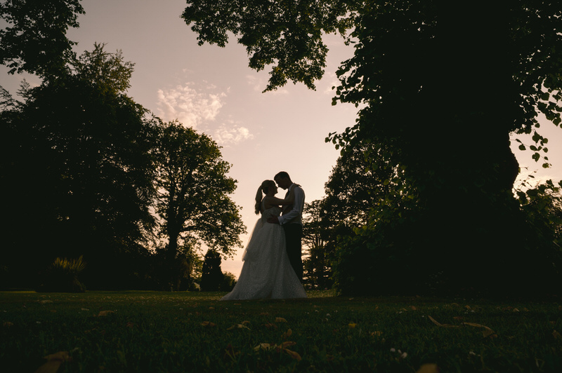 Bride & Groom outside Highfield hall wedding venue at night time under lit up pagoda 