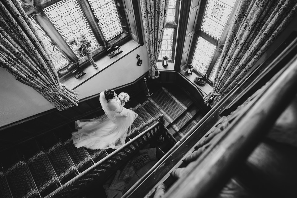 Bride walks down staircase on the way to wedding ceremony at Wigfair Hall