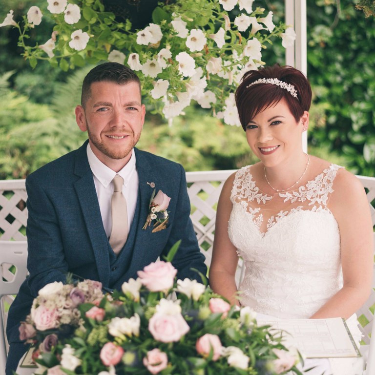 Bride and Groom sign wedding register at Highfield Hall Northop