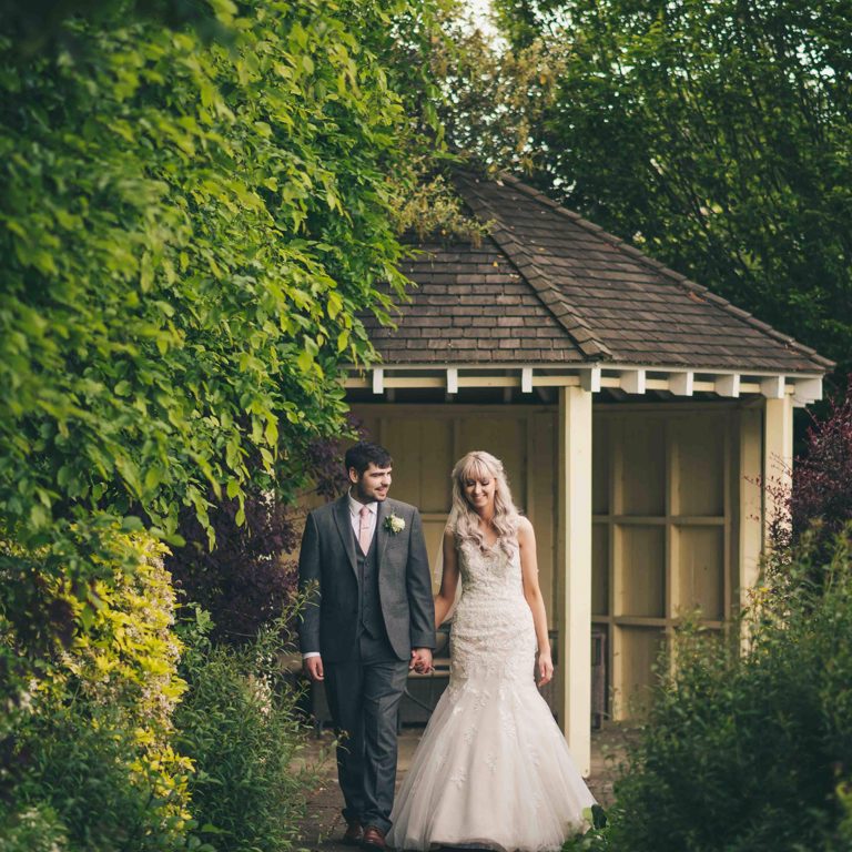 Bride & Groom take a walk through the gardens at Lion Quays during wedding