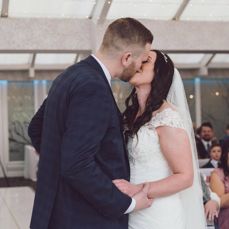 Bride & Groom kiss during ceremony at Lion Quays Oswestry