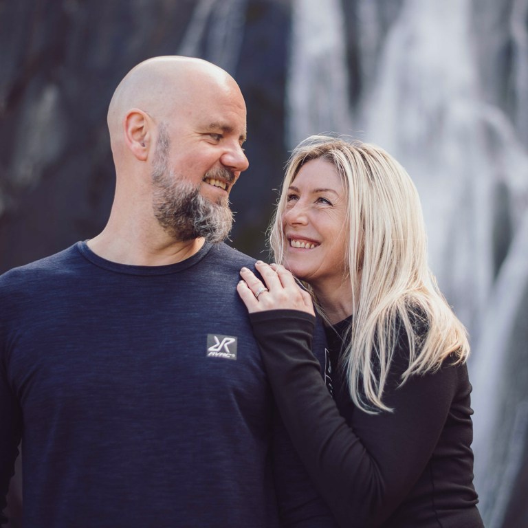 Couple looking at each other in front of Aber Falls North Wales