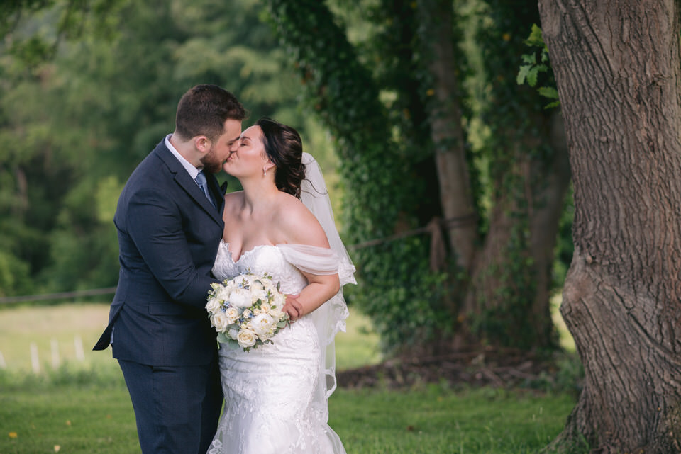 Bride & Groom kiss outside Wigfair Hall wedding, during portrait photography