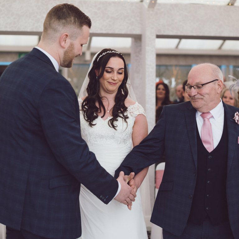 Brides Dad shakes Grooms hand during wedding ceremony at Lion Quays