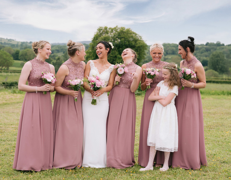 Bridal party laugh during wedding portraits in Ruthin, North Wales