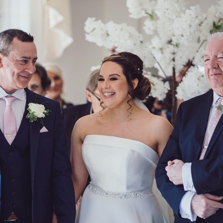 Bride, Groom and father smile during ceremony at Rossett Hall