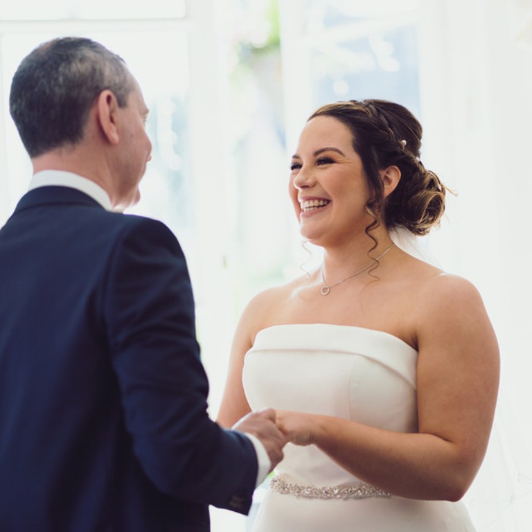 Bride laughs during ceremony at Rossett Hall North Wales