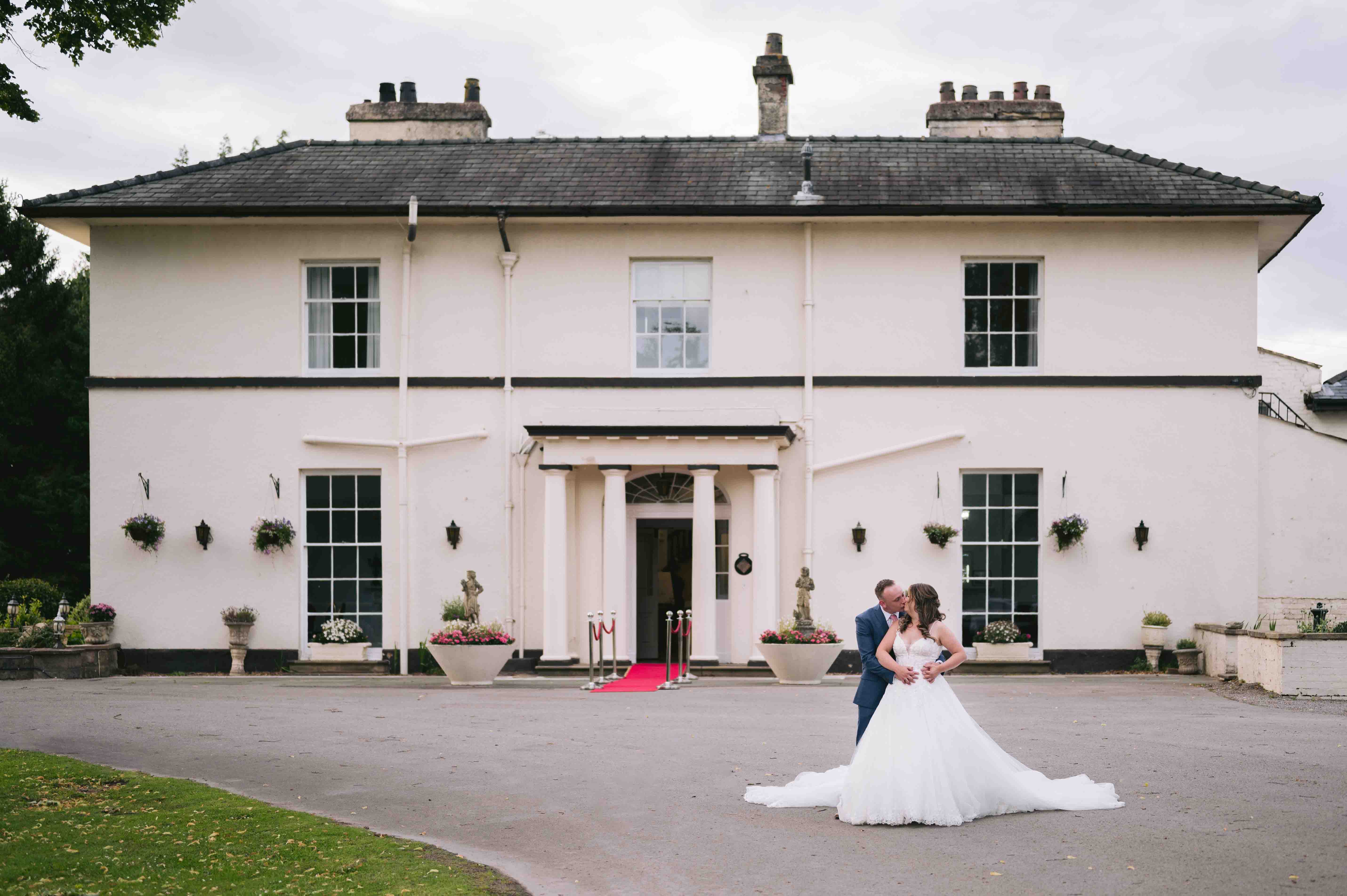 Bride & Groom kiss on wedding day at Highfield Hall wedding venue in Northop