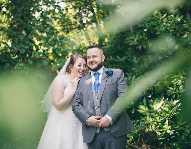 Bride & Groom smile during wedding photoshoot at Carreg Bran Anglesey