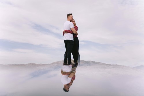 Couple hug on top of Hope Mountain, North Wales during pre wedding photoshoot